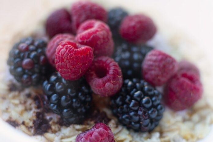 Photo by Margarita Shtyfura a bowl of oatmeal with raspberries and blueberries