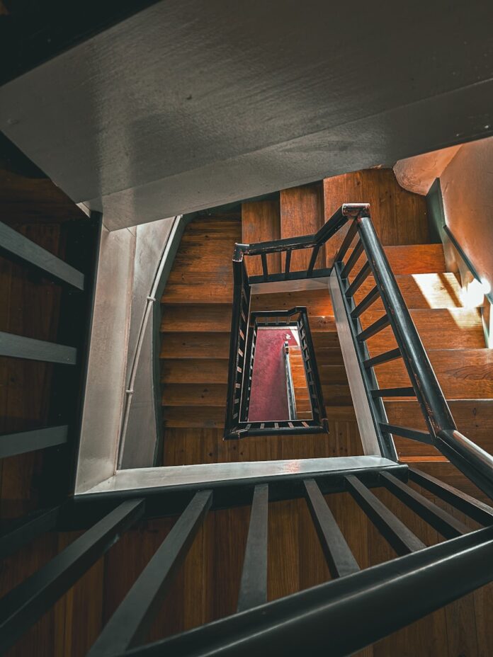 Photo by Alberto Moya a view of a staircase from the top of it