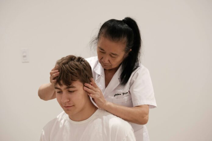 A man getting his hair cut by a woman