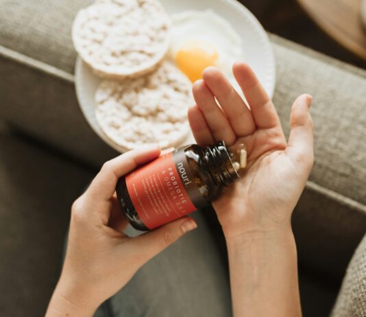 “내 몸에 맞는 영양, 똑똑하게 챙기는 실생활 보충제 활용법” person holding red bottle